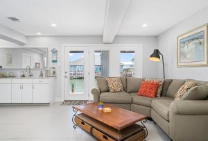 a living room with a couch and a table at Edgewater Escape in Rockport