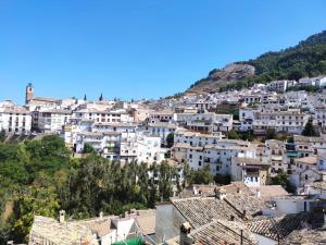 a group of white buildings on a hill at Apartamentos Peña del Castillo in Cazorla