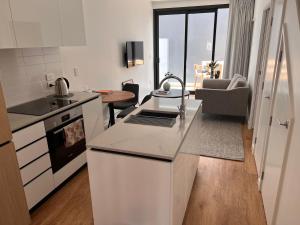a kitchen with a counter top and a living room at Stylish 2 bedrooms townhouse in central Wellington in Wellington