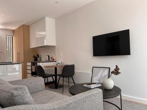 a living room with a couch and a table at Stylish 2 bedrooms townhouse in central Wellington in Wellington