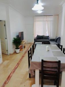 a living room with a table and a couch at Spacious 2-Bedroom Condo in Bellavista, Guayaquil in Guayaquil