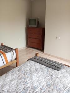 מיטה או מיטות בחדר ב-Cómo en casa