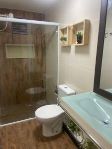 a bathroom with a toilet and a glass shower at CASAMAR Lucena in Lucena