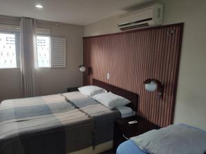 a hotel room with two beds and a television at CASAMAR Lucena in Lucena