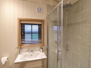 a bathroom with a sink and a shower at Lillie's Shepherds Hut in Nottingham