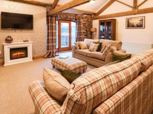 a living room with two couches and a fireplace at Sarah's Cottage in Bridlington