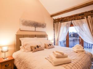 a bedroom with a bed with towels on it at Sarah's Cottage in Bridlington