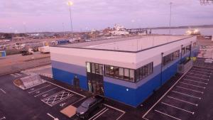 a blue and white building in a parking lot at SPECIAL PROMO! Perfect Group Accommodation, 3 Bathrooms Perfect for Contractors and Businesses with relocation Requirement near Harwich Sea Port in Harwich