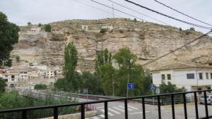a view of a mountain with houses on it at Alojamiento Rural Singular Pepe el Tranquilo in Alcalá del Júcar