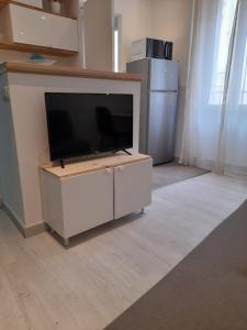 a flat screen tv sitting on top of a white cabinet at studio 29 rue des potiers in Fréjus