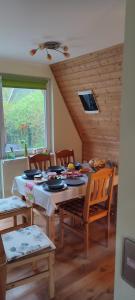 a dining room with a wooden table and chairs at Ferienhaus-Zum-Eichkater-am-Duemmer-See 