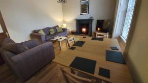 an aerial view of a living room with a table and couch at Lovely property in Central Broughty Ferry, Dundee in Broughty Ferry