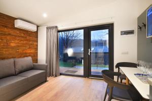 a living room with a couch and a table at Kub House Village in Slănic-Moldova