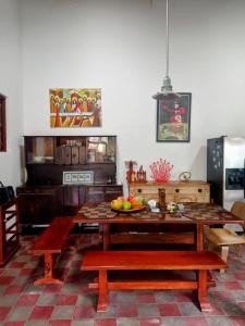 a kitchen with a table and benches in a room at Casa Yoly Hostel Granada in Granada