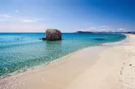 a large rock in the water on a beach at Casa Alberto in SantʼAndrea