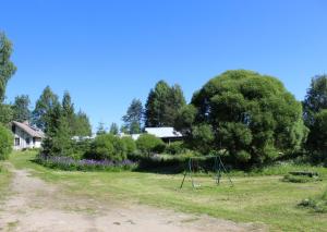 a playground in a field with a swing at Viisi Leipää in Tokrajärvi