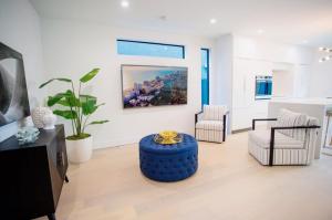 a living room with a blue ottoman in the middle at Luxury Villa in Design District (heated saltwater pool) in Miami