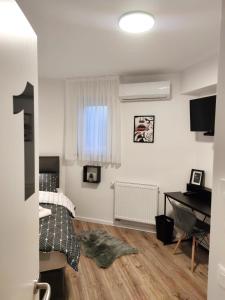 a bedroom with a bed and a desk and a piano at LaRoom - Free Parking in Zagreb