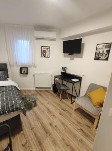 a bedroom with a bed and a desk with a computer at LaRoom - Free Parking in Zagreb