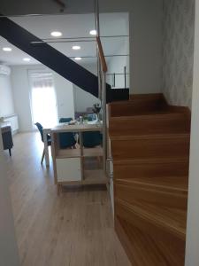 a room with a staircase with a desk and a table at Apartamentos Adarve in Ciudad-Rodrigo