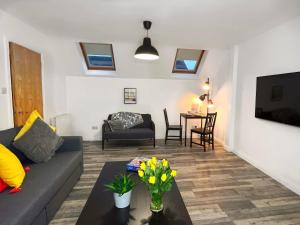 a living room with a couch and a table at Harland View Apartment in Belfast