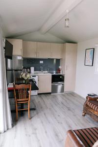a kitchen with a table and a kitchen with a couch at Birds Eye View in Havelock North
