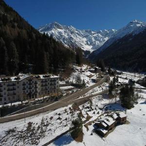 an aerial view of a city with snow covered mountains at Appartamento 50 mq in Palace Ponte di Legno in Ponte di Legno