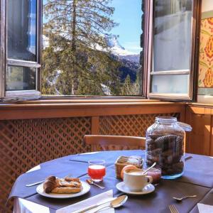 a table with a blue table cloth and food on it at Appartamento 50 mq in Palace Ponte di Legno in Ponte di Legno