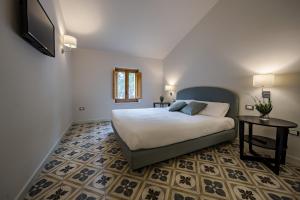 Postel nebo postele na pokoji v ubytování Masseria Agriturismo Torre Di Albidona + 37 fotografií