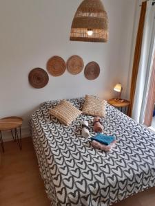 a bed in a bedroom with baskets on the wall at Large apartment near the beaches of Mourillon in Toulon