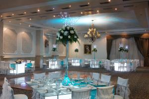 a banquet hall with white tables and white chairs at Hotel Rio Amazonas in Quito