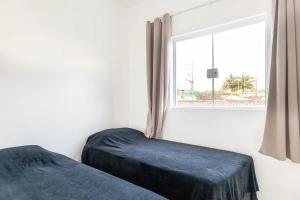 Giường trong phòng chung tại Casa Com 4 Quartos Centro