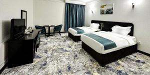 Postel nebo postele na pokoji v ubytování Al Massa Hotel