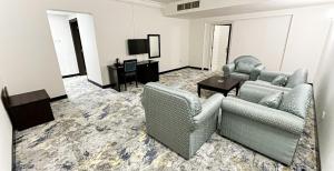 a living room with two couches and a table at Al Massa Hotel in Al Ain