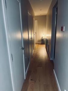 a hallway with a wooden floor and a hallway with doors at 2 Bed fully furnished apartment in Cookstown