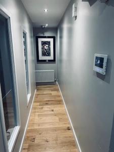 a hallway with a wooden floor in a room at 2 Bed fully furnished apartment in Cookstown