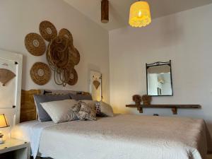 a bedroom with a bed and a mirror on the wall at ALONI G&A Archaggelos in Archangelos