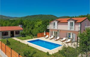 a villa with a swimming pool and a house at Awesome Home In Poljica Imotska With Outdoor Swimming Pool in Margete