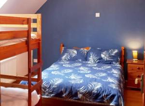 a bedroom with a bed and a bunk bed at Sarlyn Holiday Home Achill in River