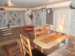 a living room with a table and chairs and a couch at 'The Cabin'. A cosy private & secure holiday home. in Padeswood +50 photos