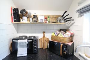 a kitchen with a counter top with two microwaves at Garden Studio in Biggar in Biggar