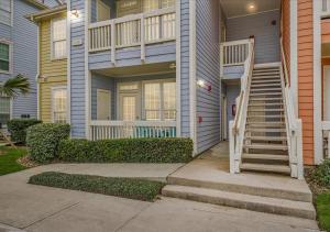 a house with a staircase leading up to a house at The Dawn on Galveston Beach in Galveston