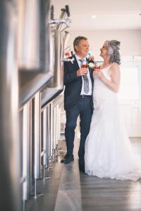 a bride and groom drinking wine at their wedding reception at Bumblebee Bight Inn in Pilleyʼs Island
