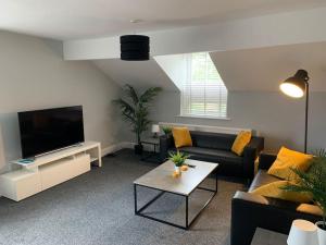 a living room with a couch and a tv at Fantastic Large 2 X Bedroom Flat, Free Parking in Sale