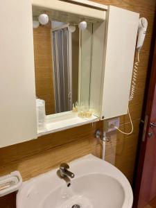 a bathroom with a sink and a mirror at B&B Snow Village Roccaraso in Roccaraso