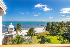 a view of a beach with palm trees and the ocean at Lighthouse Beach Villas in San Pedro