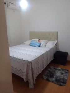 a small bed in a room with a white mattress at Apartamento em Cuiabá in Cuiabá