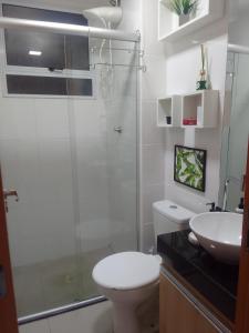 a bathroom with a shower and a toilet and a sink at Apartamento em Cuiabá in Cuiabá