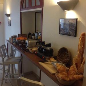 a counter with a table with bread and a mirror at Le Petit Hôtel in Biarritz