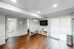 an empty living room with a television and a chair at Bungalow by the Bay in Netarts +12 photos
